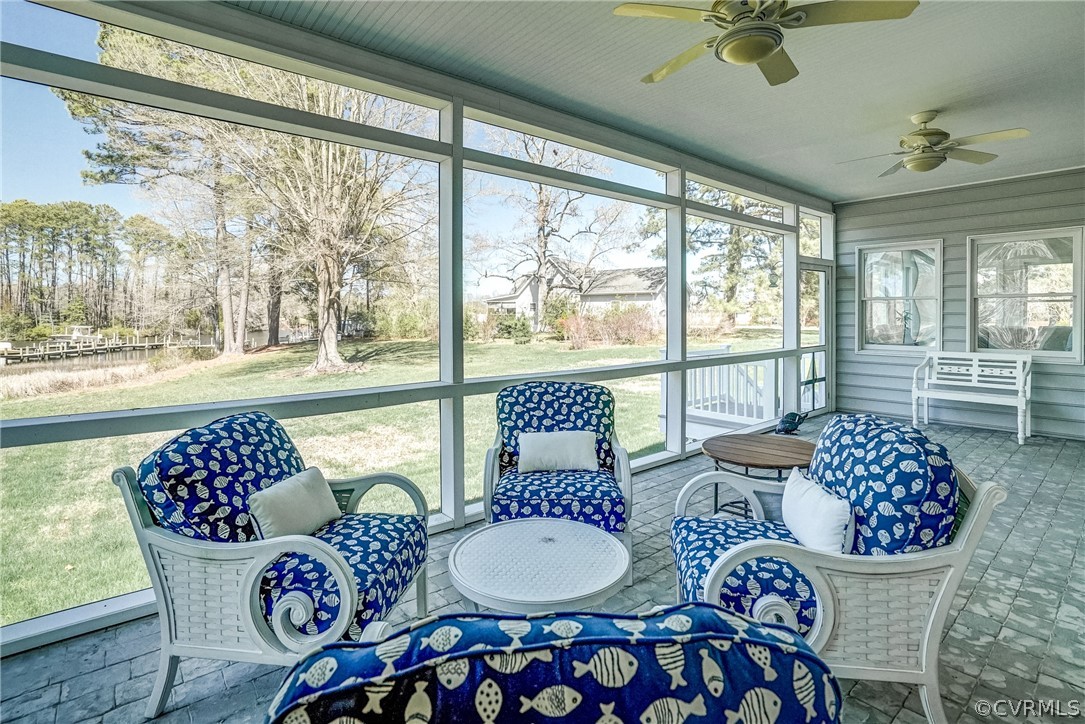 253 Prentice Point Drive Kilmarnock, VA 22482 - Photo 30 of 44 a living room with furniture and a floor to ceiling window