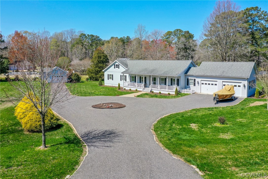 253 Prentice Point Drive Kilmarnock, VA 22482 - Photo 3 of 44 a view of a house with a big yard plants and large trees
