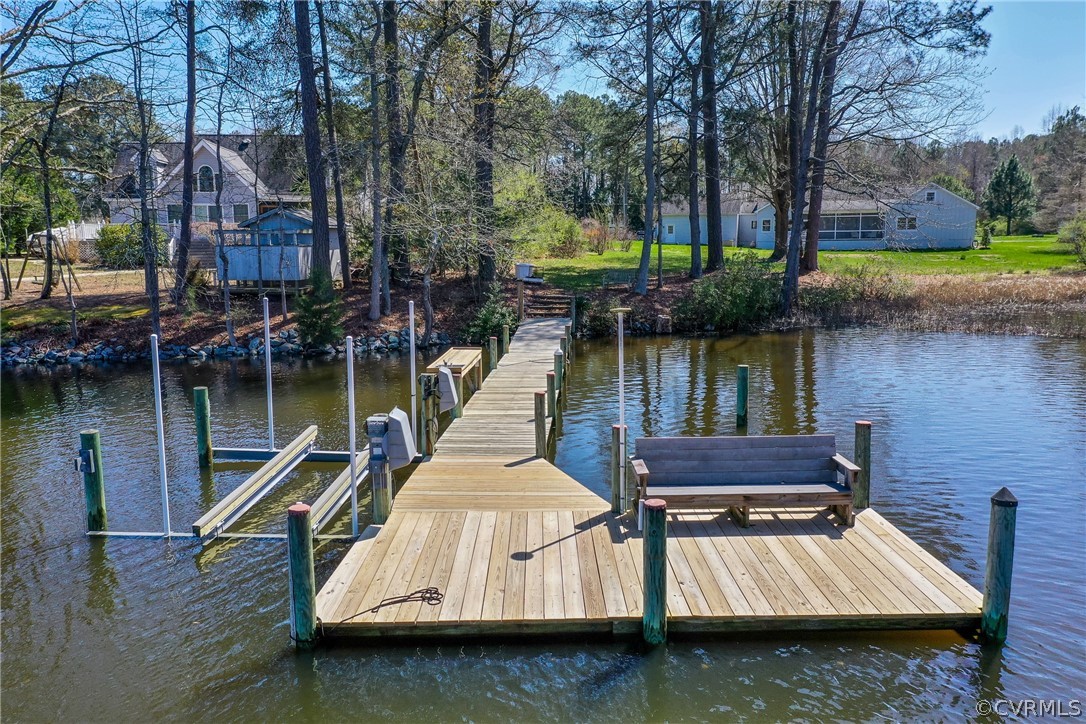 253 Prentice Point Drive Kilmarnock, VA 22482 - Photo 35 of 44 a wooden bench sitting next to a lake