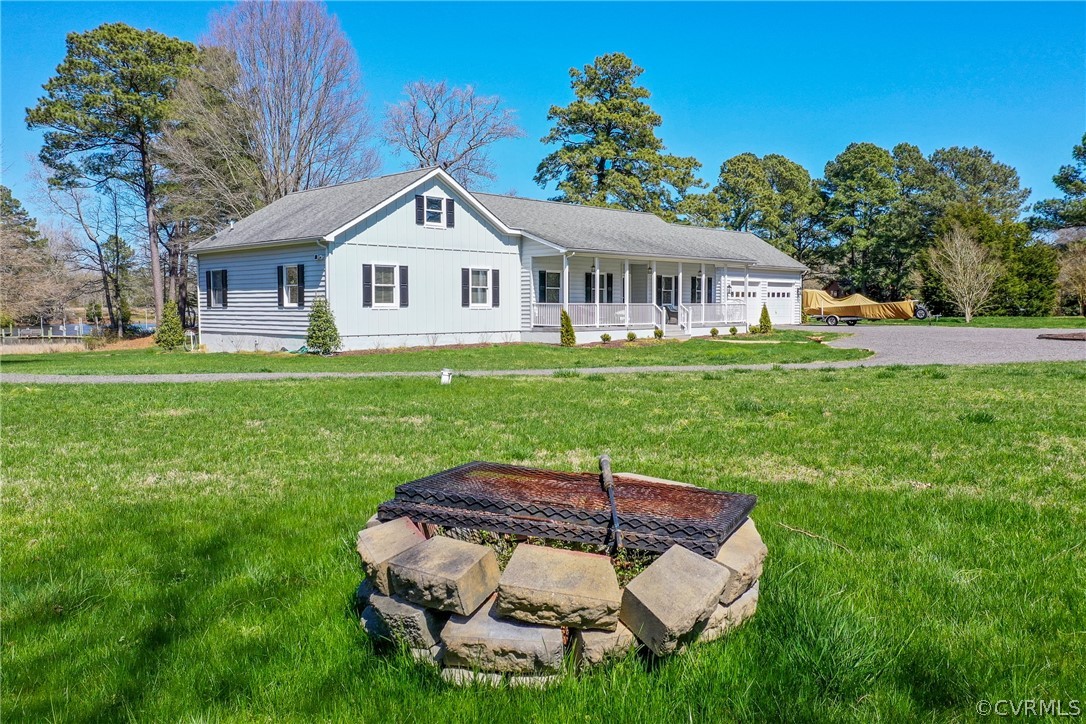253 Prentice Point Drive Kilmarnock, VA 22482 - Photo 41 of 44 a backyard of a house with table and chairs