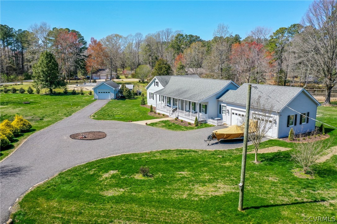 253 Prentice Point Drive Kilmarnock, VA 22482 - Photo 44 of 44 a view of a house with a big yard plants and large tree