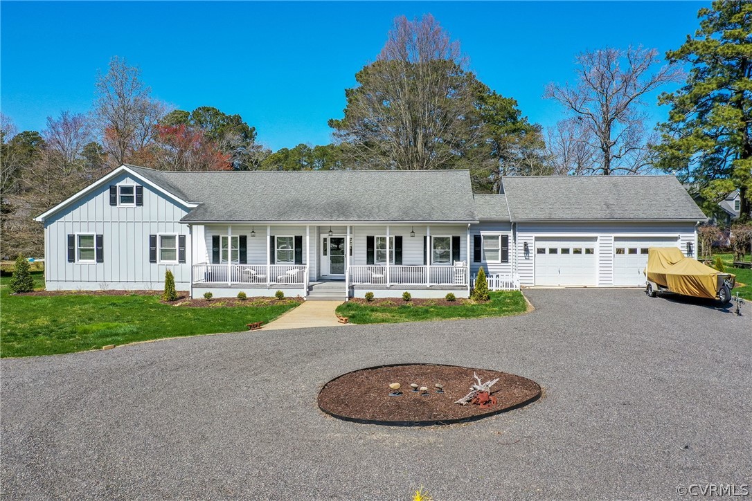 253 Prentice Point Drive Kilmarnock, VA 22482 - Photo 5 of 44 a front view of a house with a garden and yard