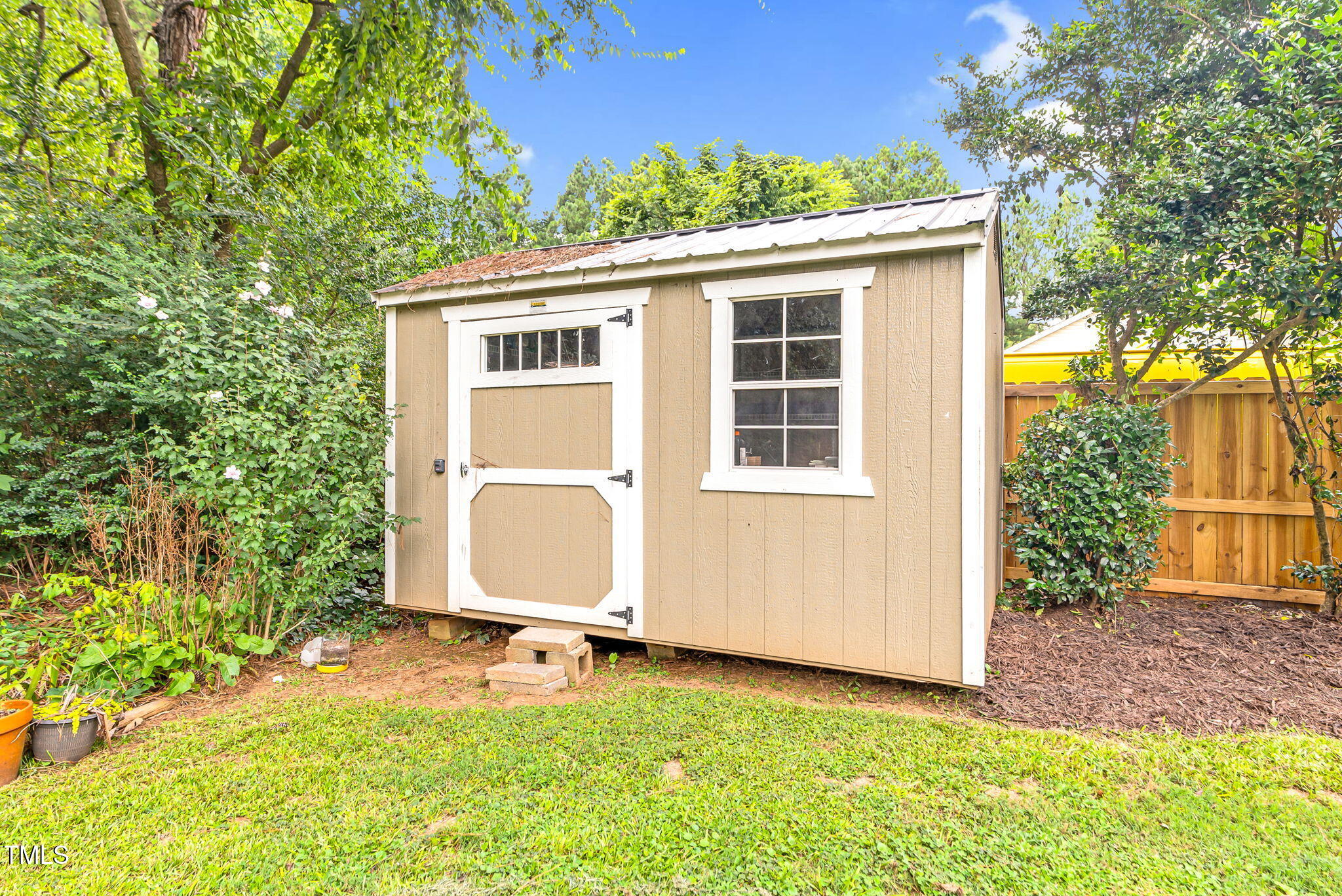 243 Toomer Loop Road Pittsboro, NC 27312 - Photo 11 of 42 a view of a backyard with a large tree