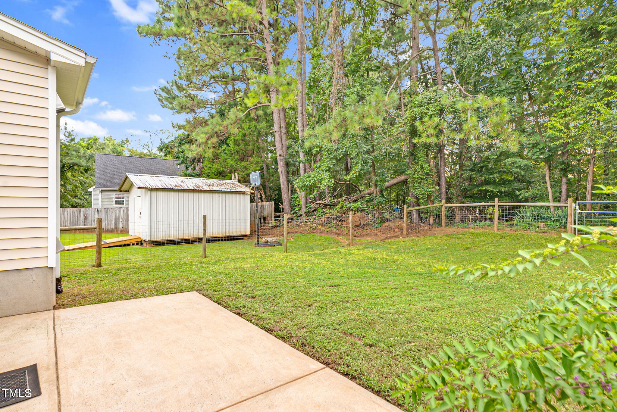243 Toomer Loop Road Pittsboro, NC 27312 - Photo 15 of 42 a view of a backyard with table and chairs and potted plants