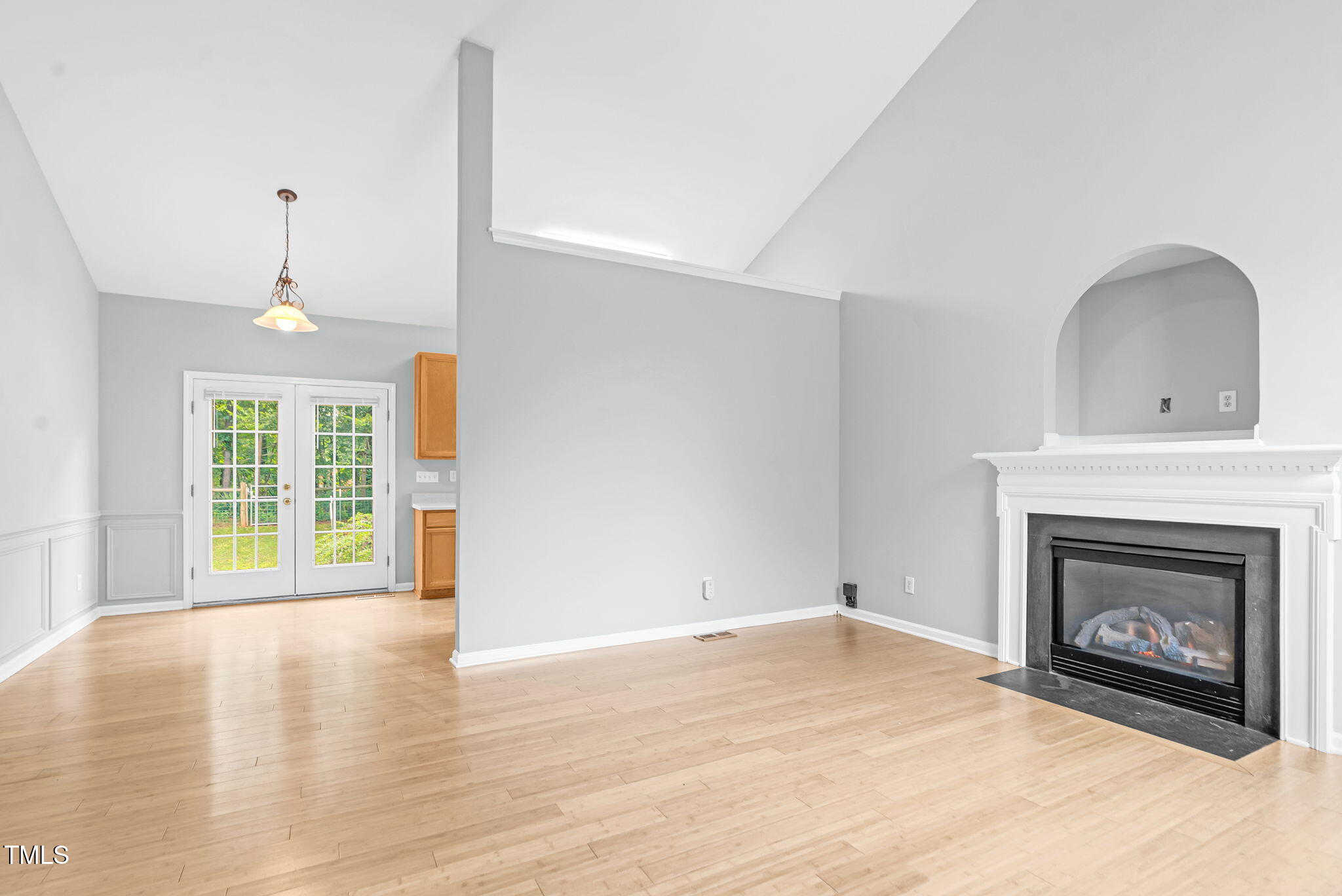 243 Toomer Loop Road Pittsboro, NC 27312 - Photo 20 of 42 a view of an empty room with a fireplace and a window
