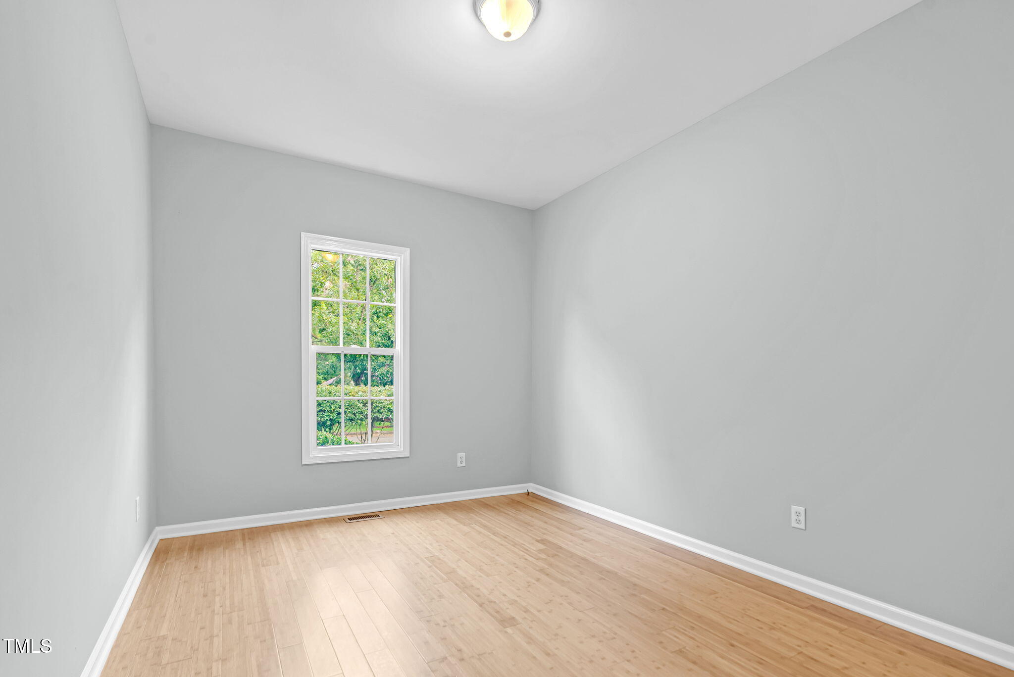243 Toomer Loop Road Pittsboro, NC 27312 - Photo 26 of 42 wooden floor in an empty room with a window