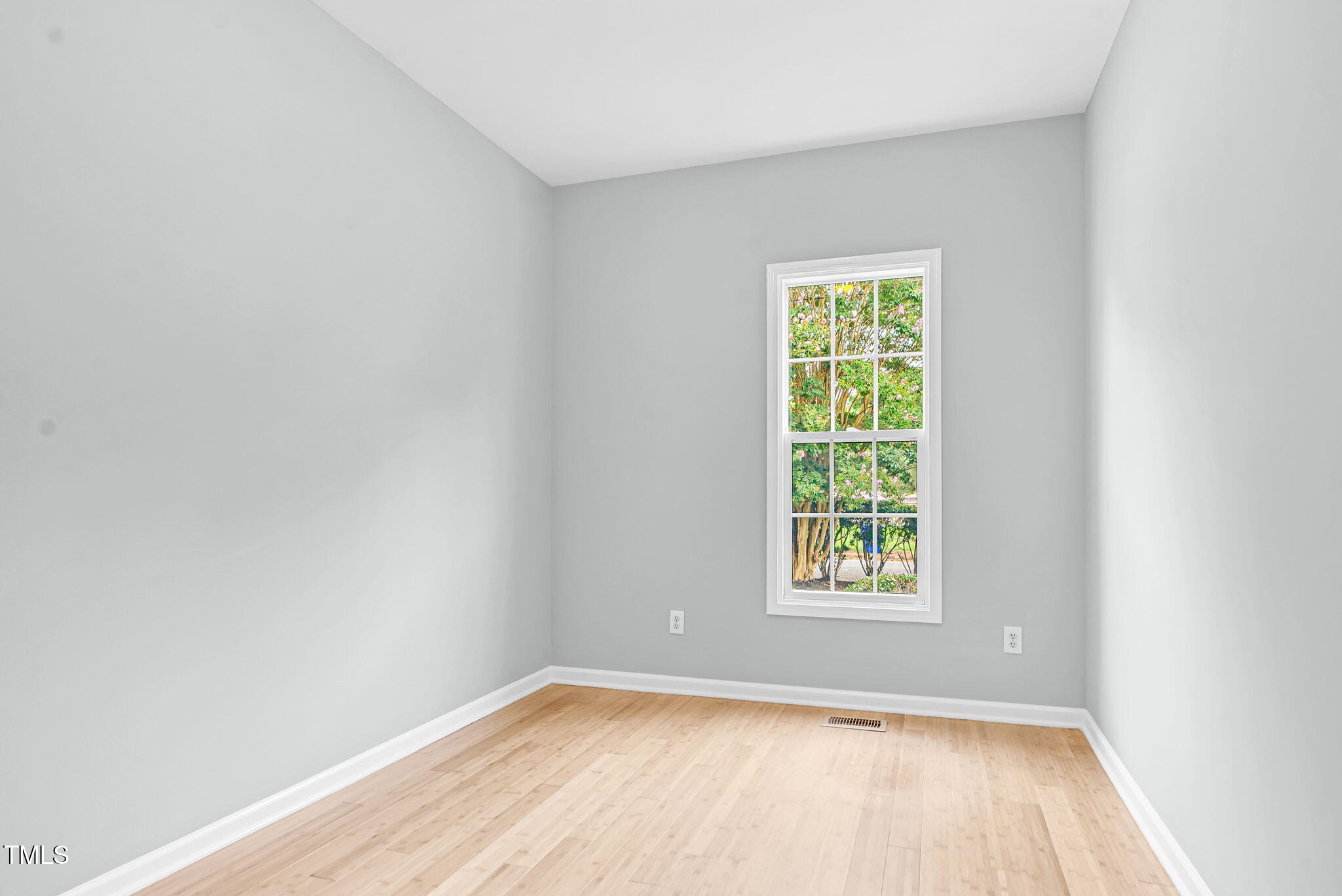 243 Toomer Loop Road Pittsboro, NC 27312 - Photo 28 of 42 a view of an empty room with wooden floor and a window