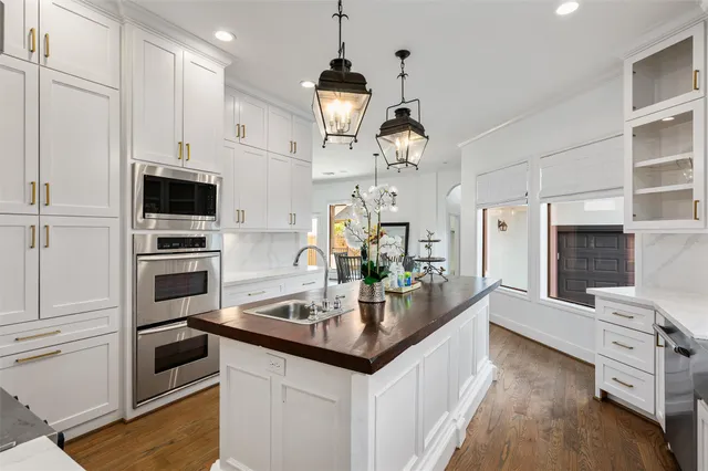 a kitchen with granite countertop a sink stove and refrigerator