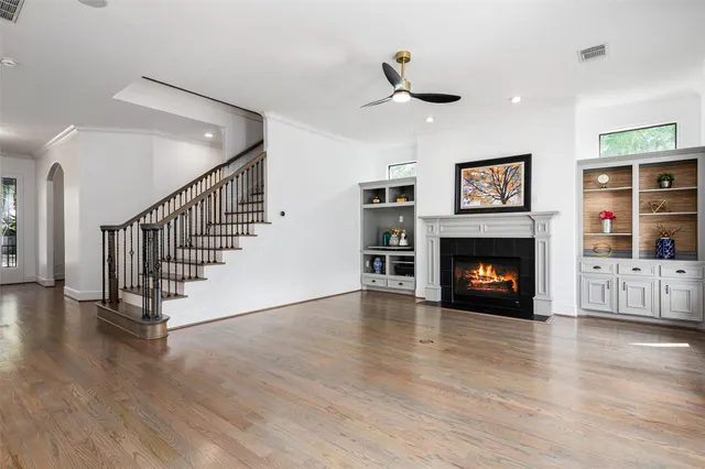 a view of a livingroom with a fireplace wooden floor and window