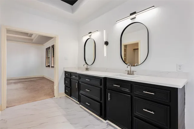a bathroom with a double vanity sink a mirror and a shower