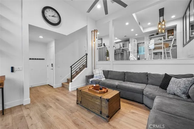 a living room with furniture and a wall painting