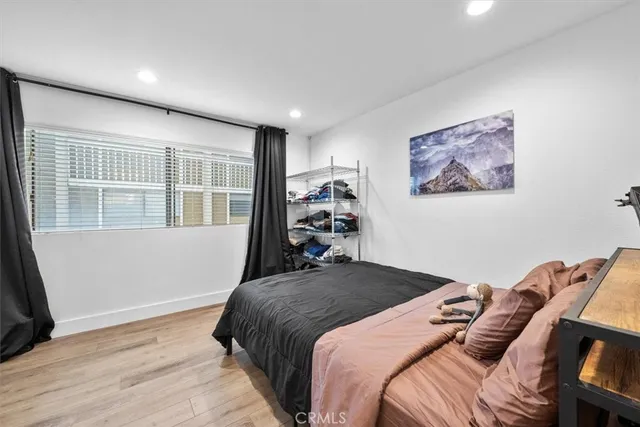 a spacious bedroom with a bed and a window