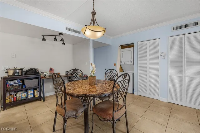 a view of a dining room with furniture and a chandelier