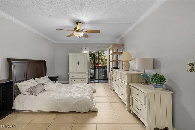 a bedroom with a bed and ceiling fan