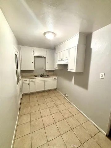 a kitchen with stainless steel appliances a refrigerator sink and cabinets