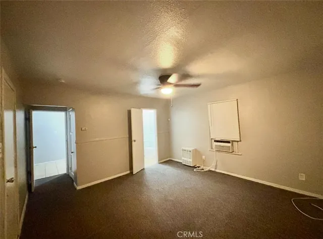 an empty room with a empty space and a ceiling fan