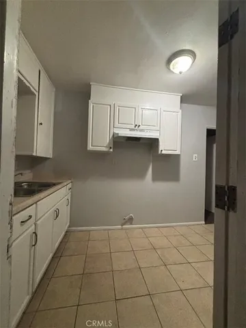 a kitchen with cabinets and a stove top oven