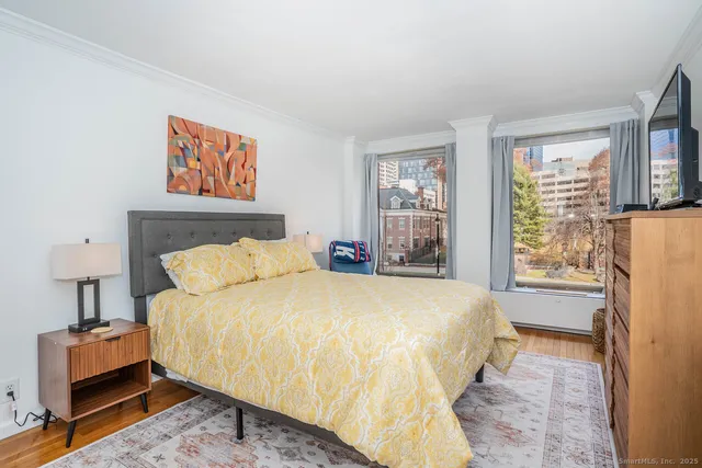 a bedroom with bed and a couch