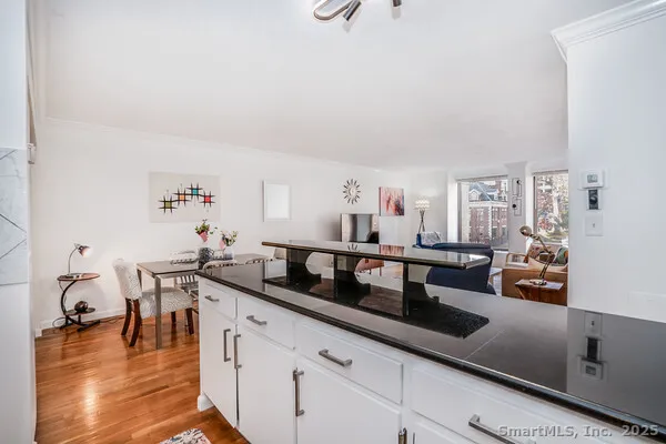 a kitchen with counter top space and living room