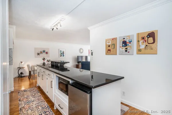 a large white kitchen with a sink and dishwasher