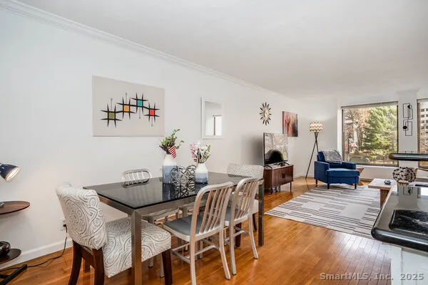 a dining room with furniture window and wooden floor