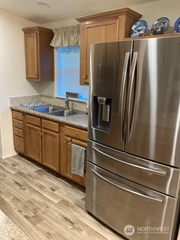 a kitchen with stainless steel appliances granite countertop a stove a microwave and a sink