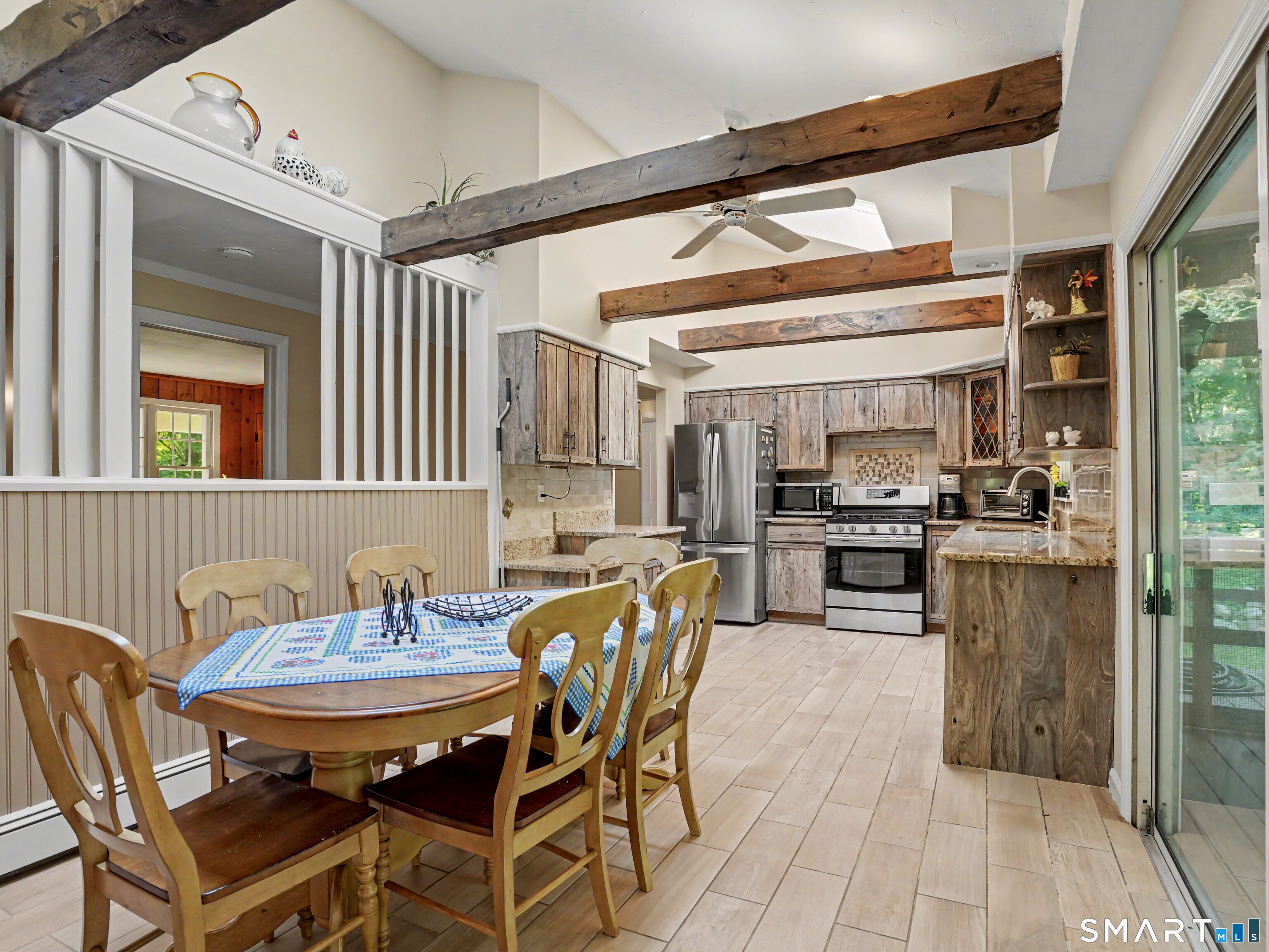 15 Flat Rock Drive Ridgefield, CT 06877 - Photo 13 of 39 a dining room with stainless steel appliances kitchen island granite countertop a sink and chairs