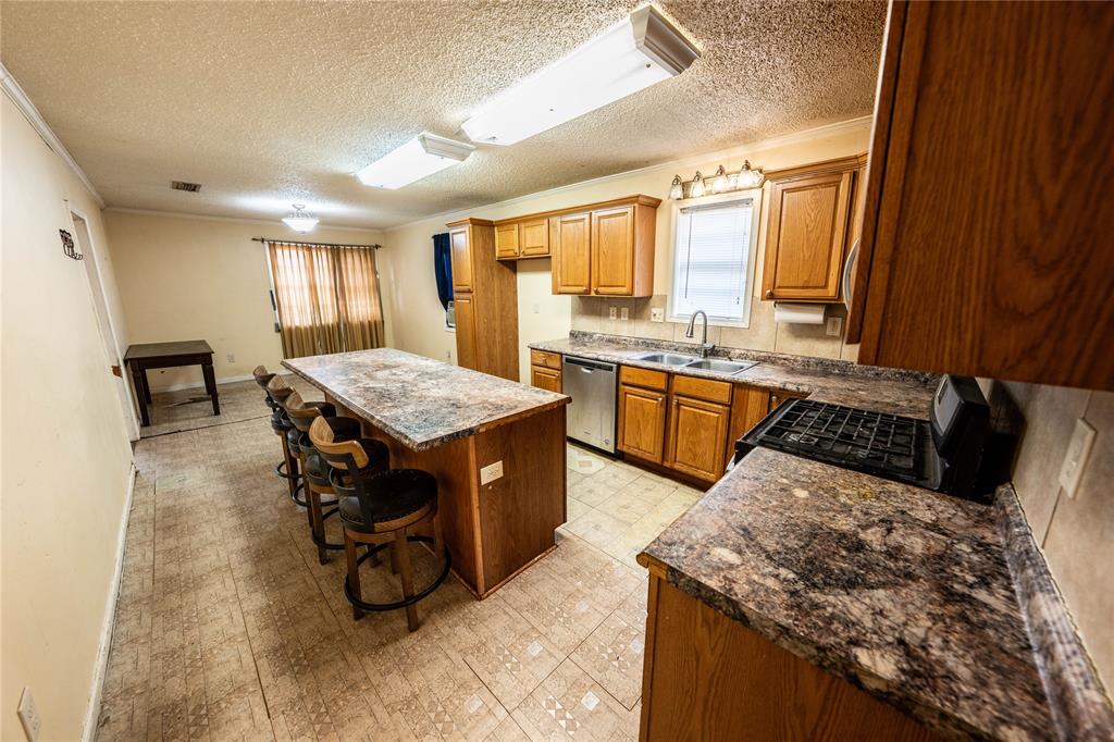 7341 Broadacres Road Shreveport, LA 71129 - Photo 13 of 23 a kitchen with a stove a sink and a refrigerator