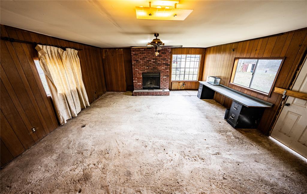 7341 Broadacres Road Shreveport, LA 71129 - Photo 16 of 23 a view of an empty room with a fireplace and a window