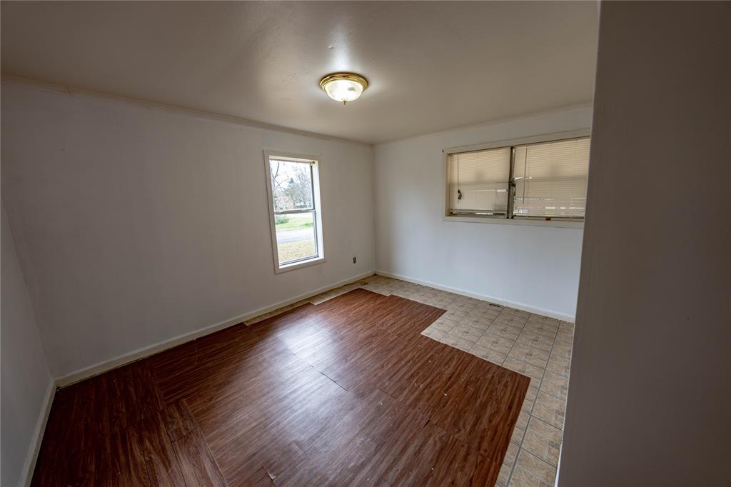 7341 Broadacres Road Shreveport, LA 71129 - Photo 2 of 23 an empty room with wooden floor and windows