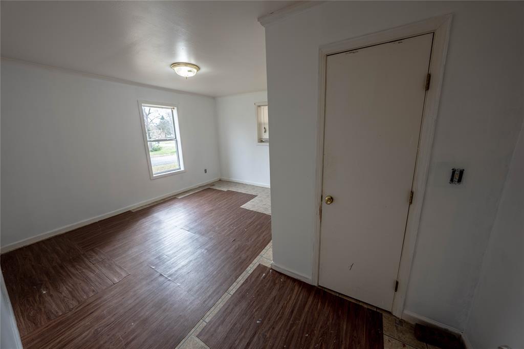 7341 Broadacres Road Shreveport, LA 71129 - Photo 4 of 23 a view of an empty room with wooden floor and a window