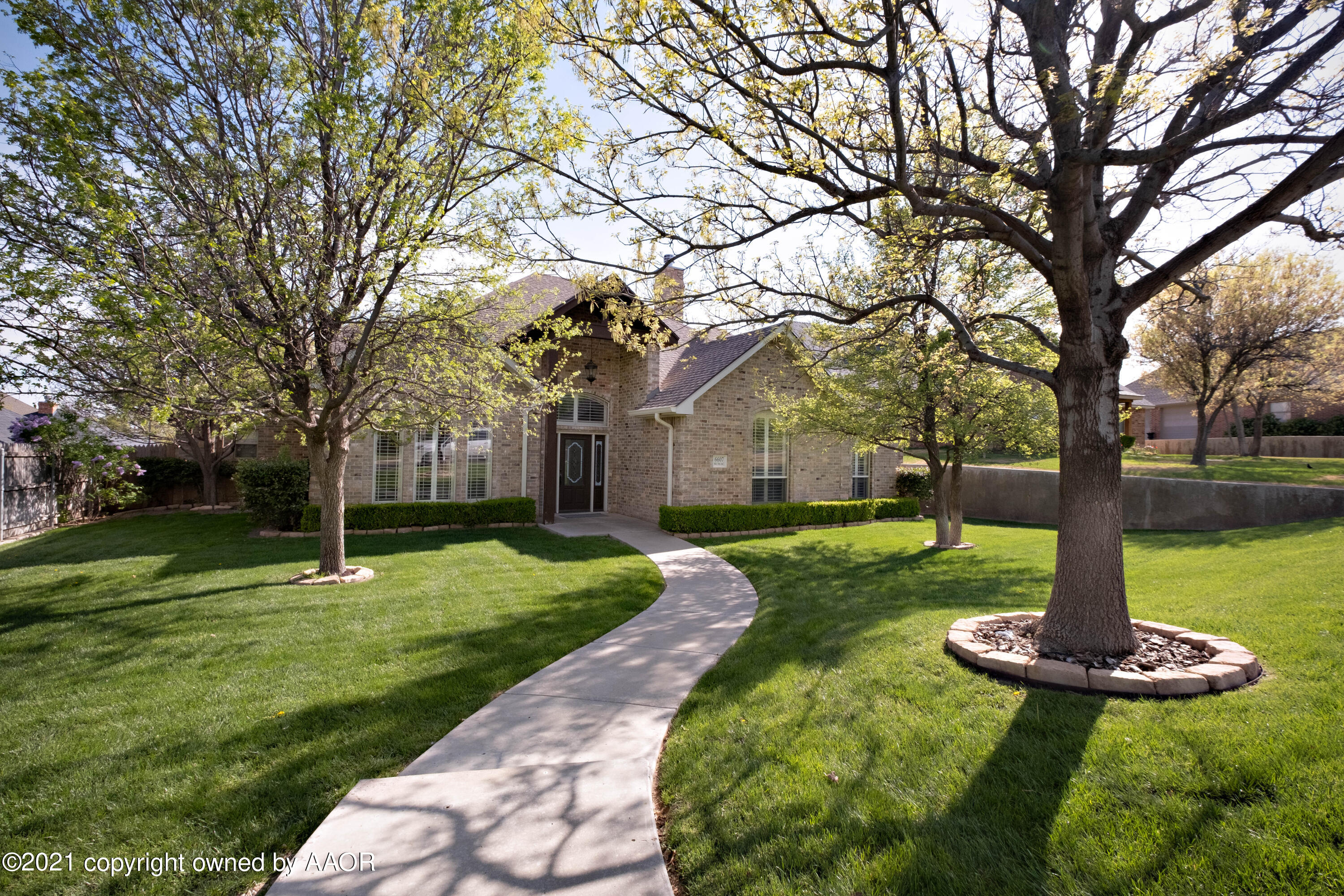 a green field with lots of trees