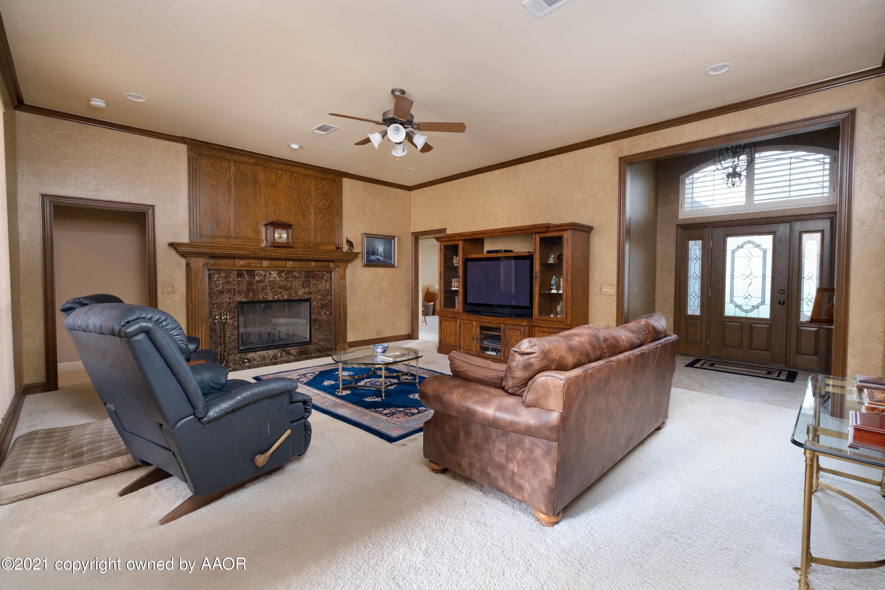 6607 Sumac Place Amarillo, TX 79124 - Photo 11 of 32 a living room with furniture a fireplace and a flat screen tv