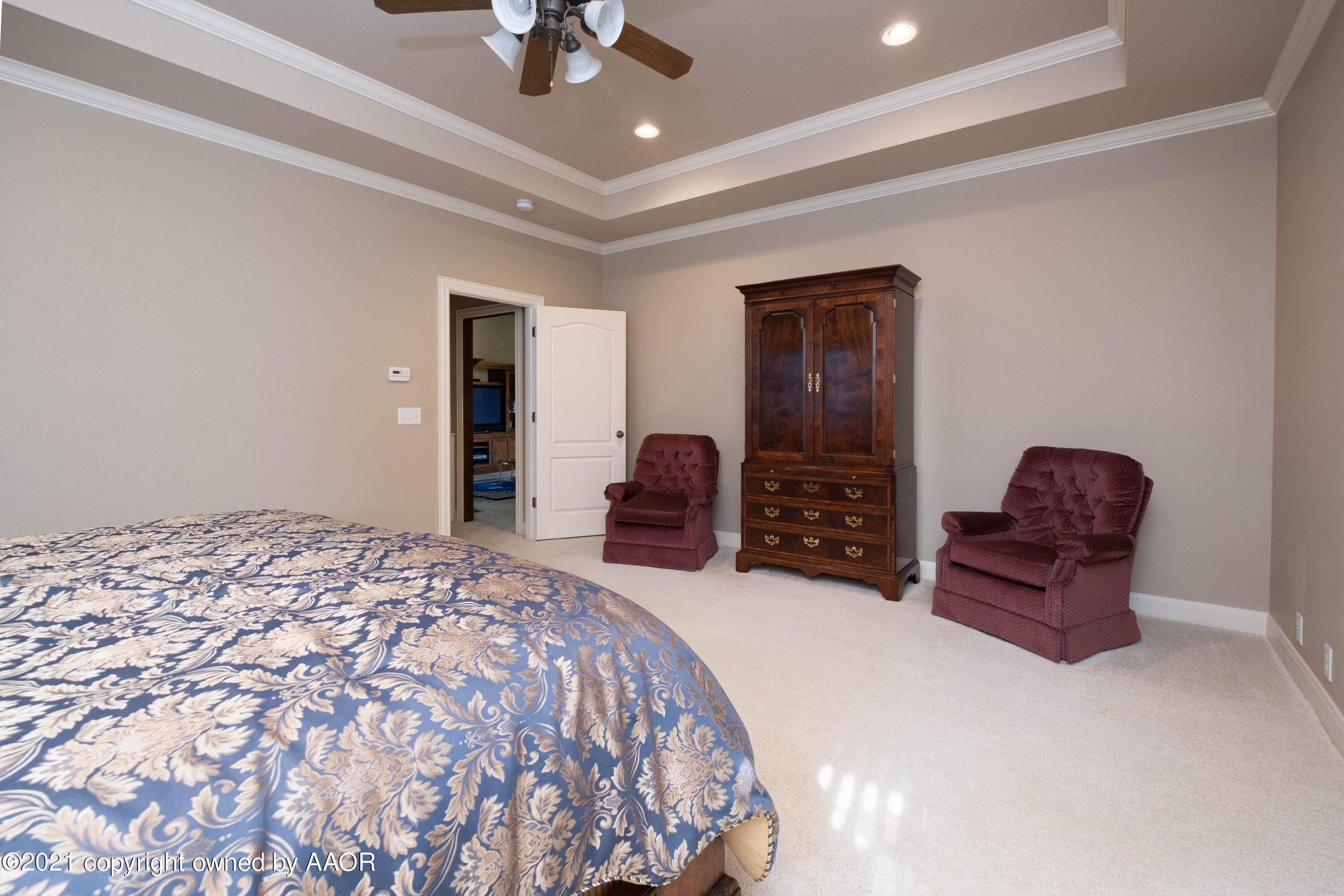 6607 Sumac Place Amarillo, TX 79124 - Photo 15 of 32 a bedroom with a bed and a chandelier