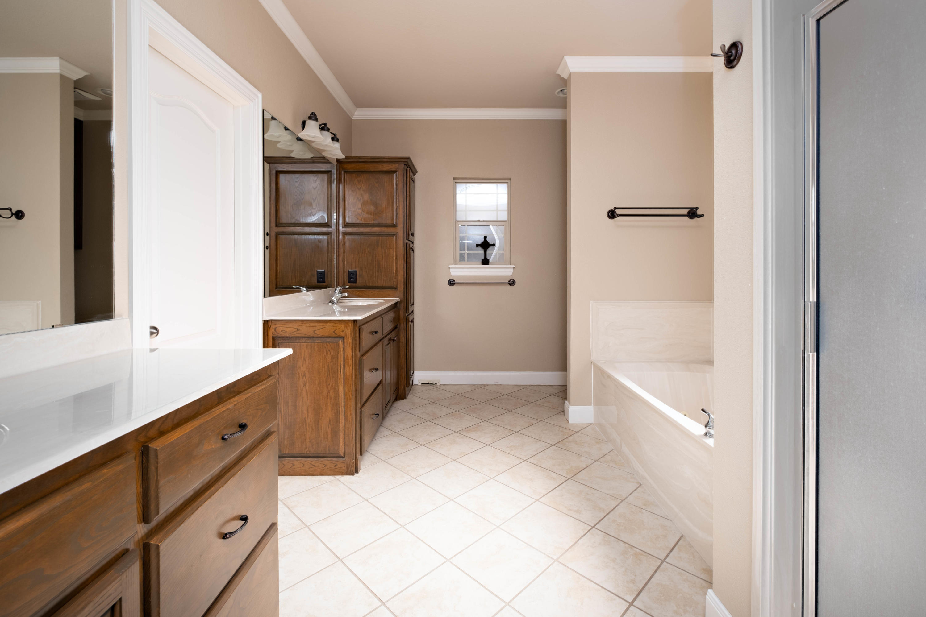 6607 Sumac Place Amarillo, TX 79124 - Photo 16 of 32 a large white bathroom with a double vanity sink a mirror and a bathtub