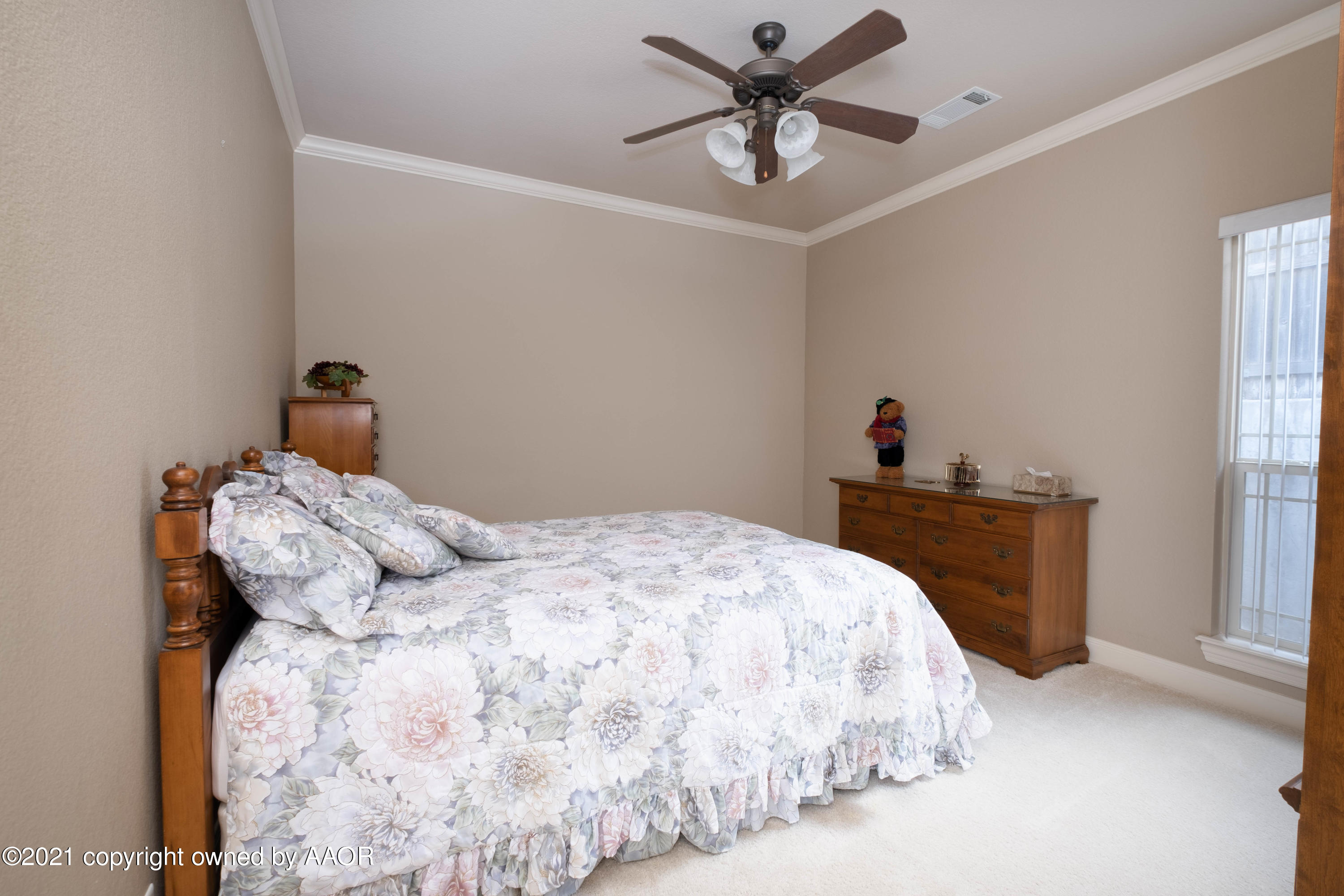 6607 Sumac Place Amarillo, TX 79124 - Photo 24 of 32 a bedroom with a bed and a chandelier