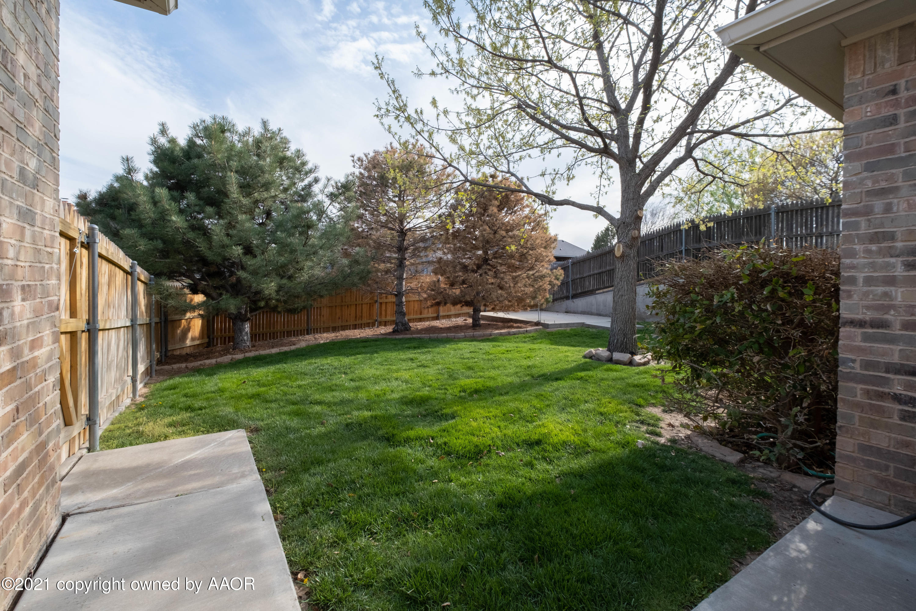 6607 Sumac Place Amarillo, TX 79124 - Photo 31 of 32 a view of a backyard with large trees