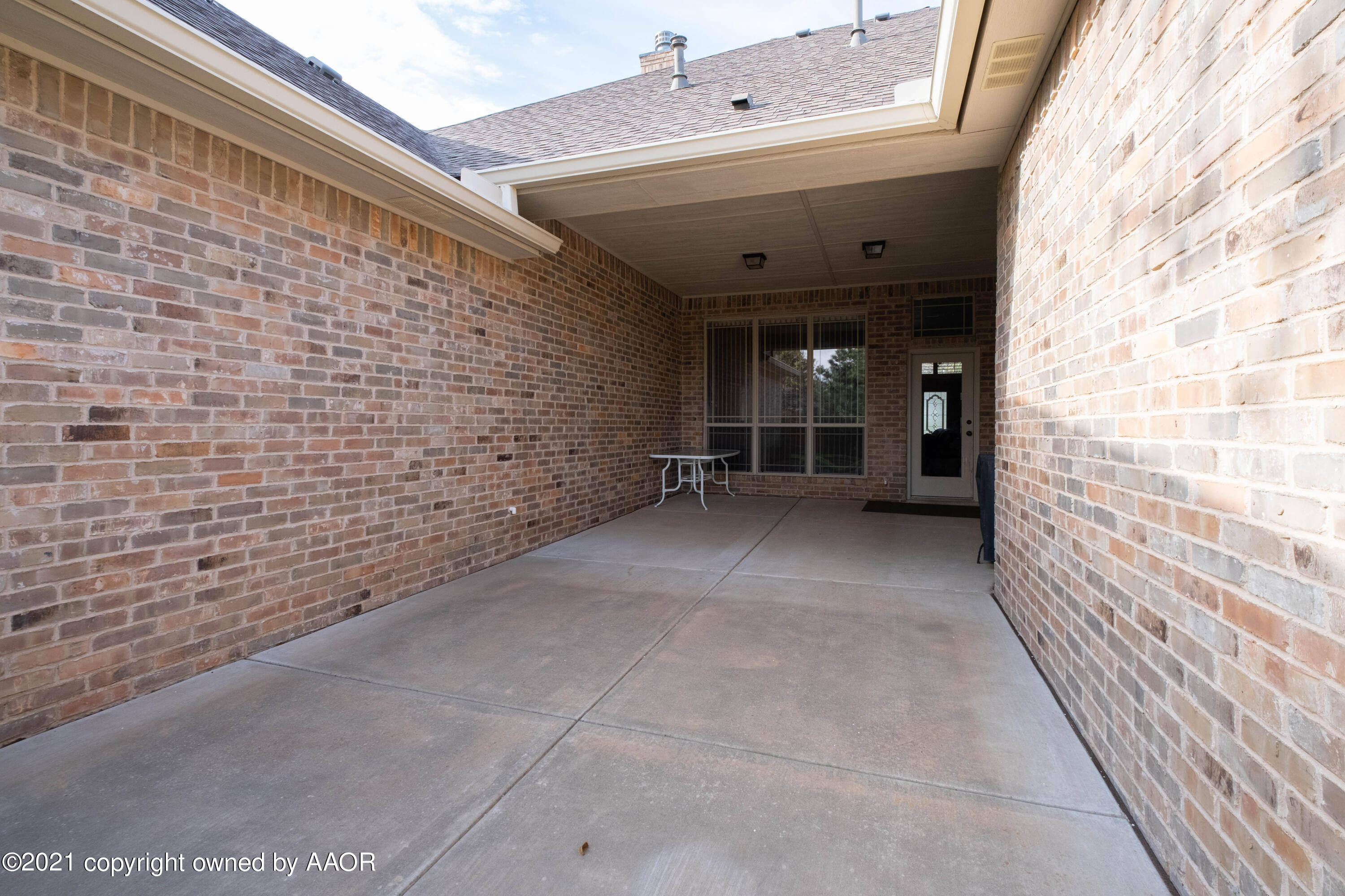 6607 Sumac Place Amarillo, TX 79124 - Photo 32 of 32 a view of a hallway with wooden walls and brick wall