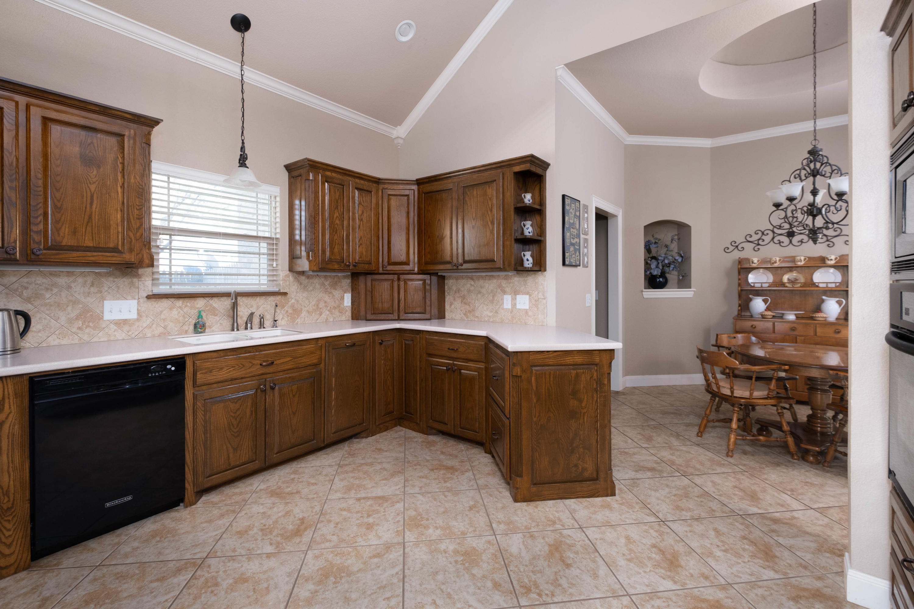6607 Sumac Place Amarillo, TX 79124 - Photo 6 of 32 a kitchen with granite countertop a sink cabinets and window