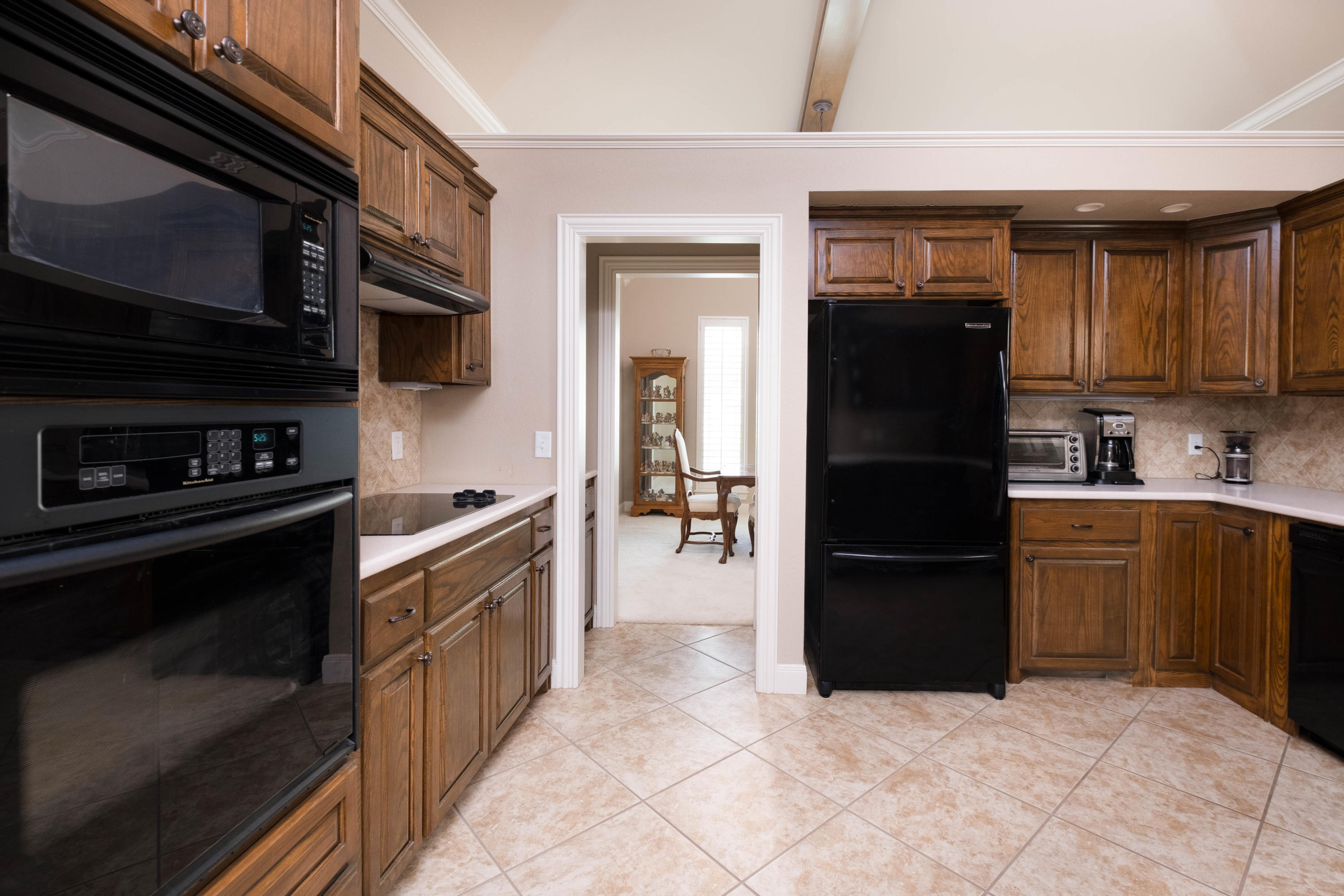 6607 Sumac Place Amarillo, TX 79124 - Photo 7 of 32 a kitchen with a refrigerator and a sink