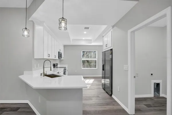 a kitchen with a stove a sink and a refrigerator