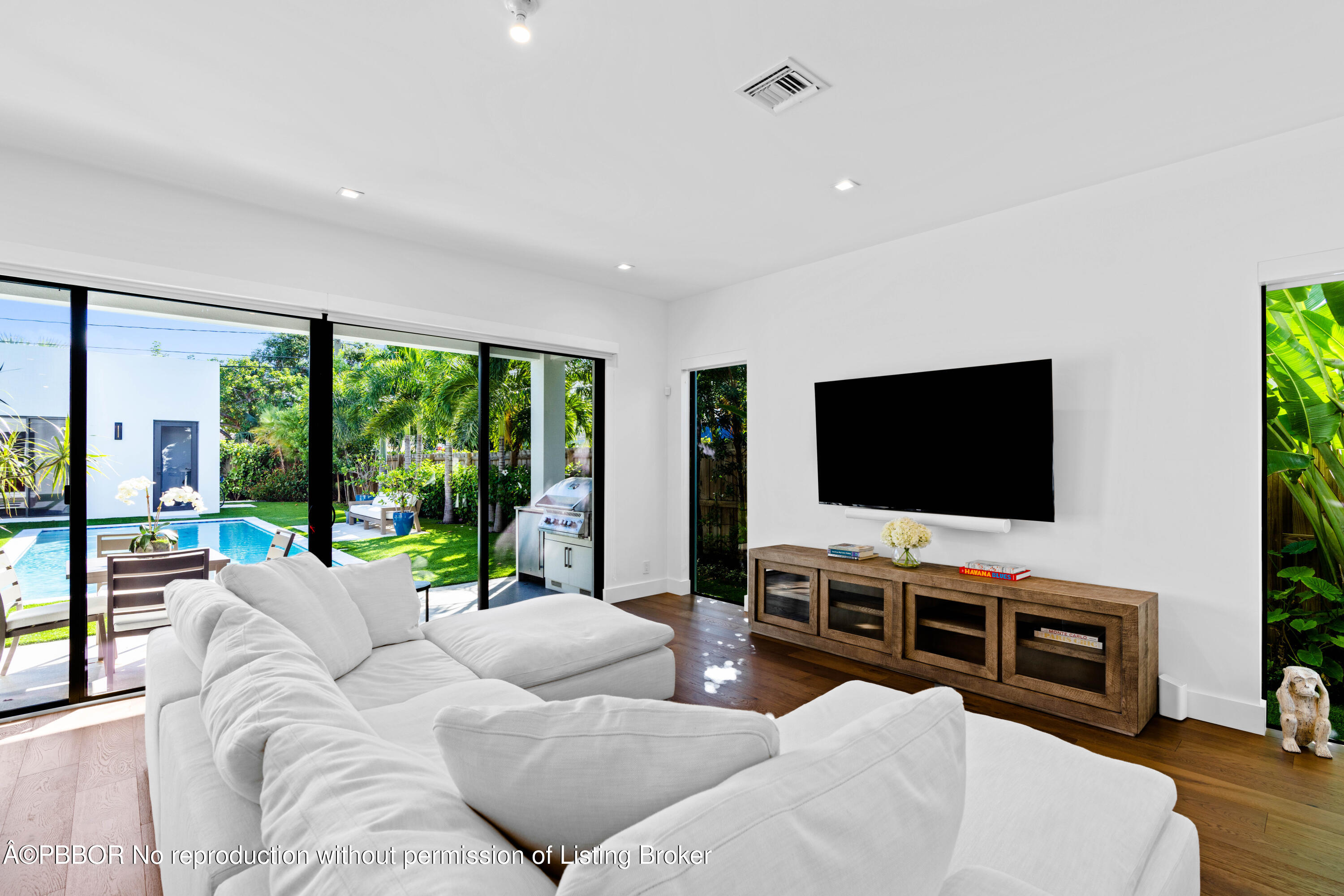 230 Seville Road West Palm Beach, FL 33405 - Photo 10 of 25 a living room with furniture a flat screen tv and a large window