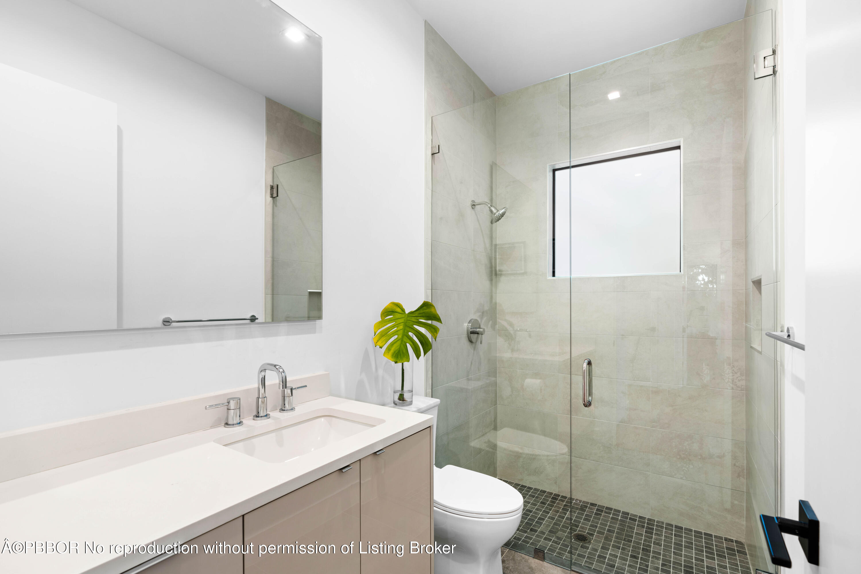 230 Seville Road West Palm Beach, FL 33405 - Photo 19 of 25 a bathroom with a granite countertop sink a toilet and a shower