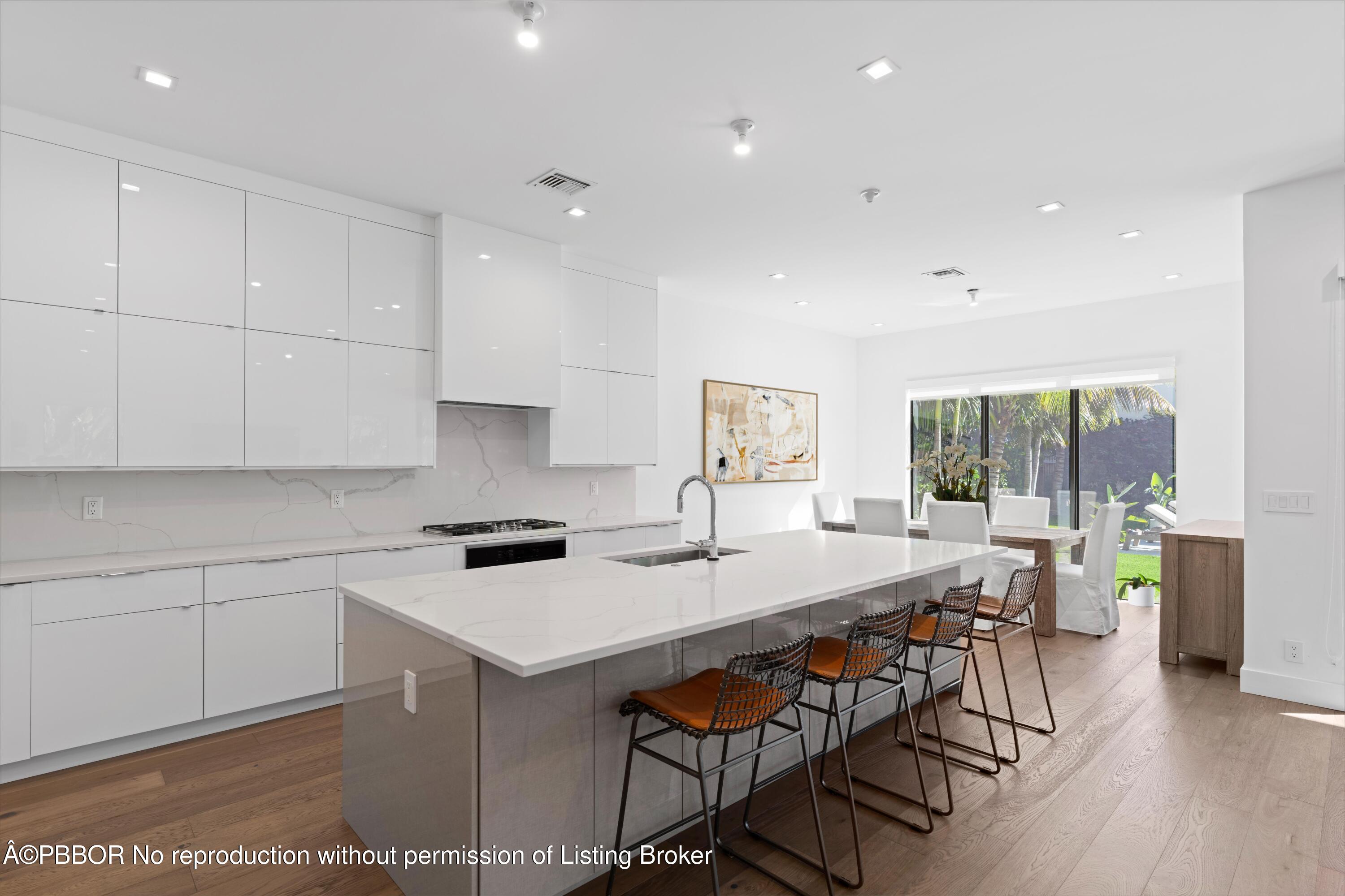 230 Seville Road West Palm Beach, FL 33405 - Photo 3 of 25 a kitchen that has a table and chairs in it