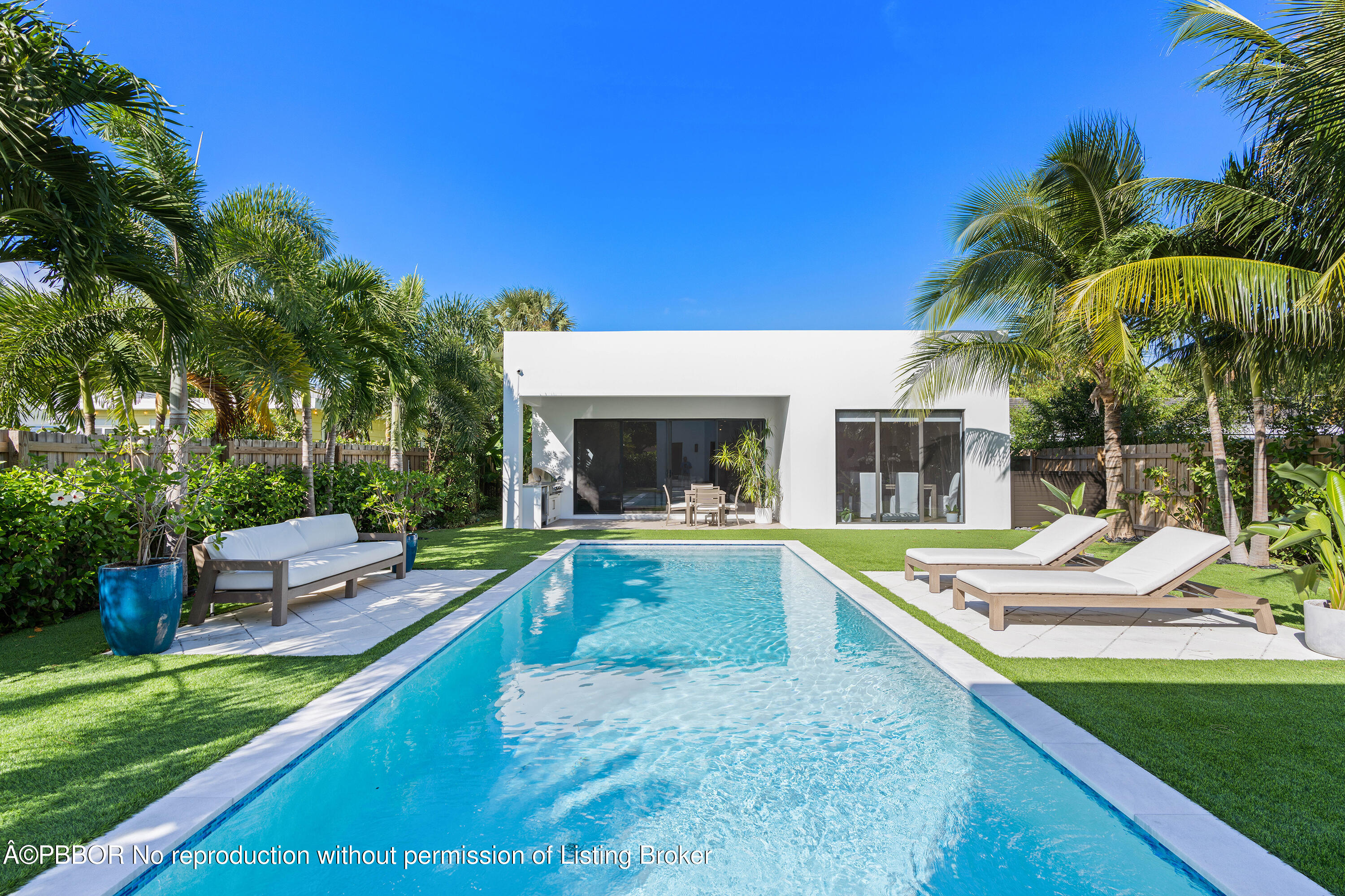 230 Seville Road West Palm Beach, FL 33405 - Photo 6 of 25 a view of house with swimming pool outdoor seating and barbeque oven