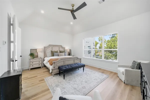a spacious bedroom with a bed a window and walk in closet