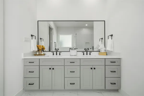 a bathroom with a double vanity sink double and a mirror