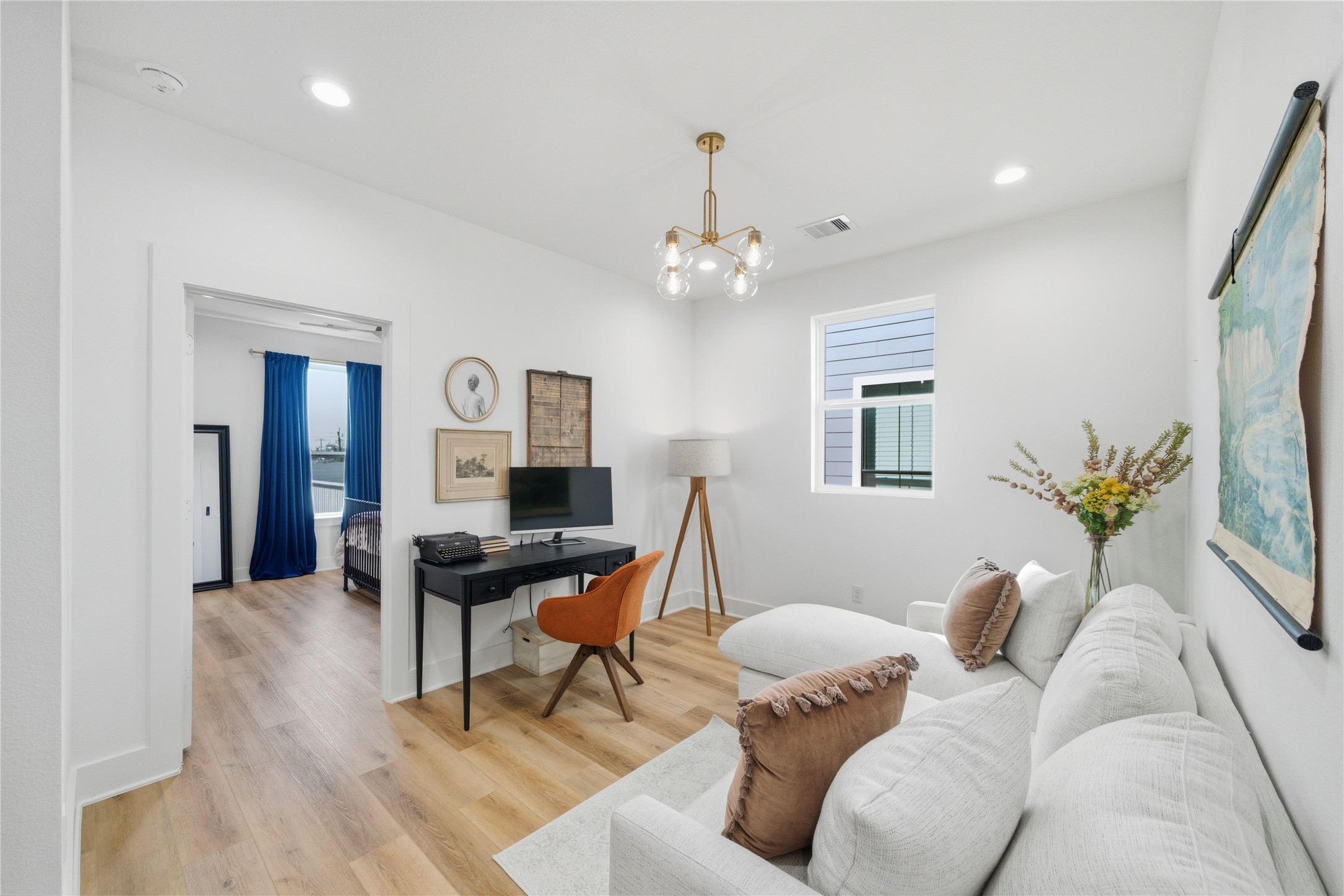 1307 East 27th Street Houston, TX 77009 - Photo 28 of 33 a living room with furniture a chandelier and a dining room