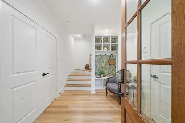 a view of entryway and hall with wooden floor