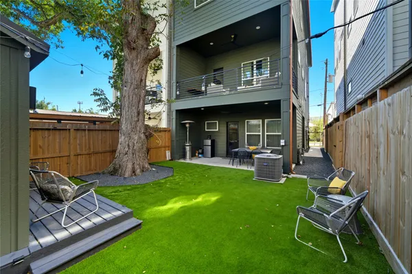 a view of a backyard with table and chairs and a fire pit